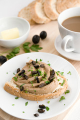 liver pate and butter sandwich with olives and parsley chopps, cappuccino, butter, and white bread