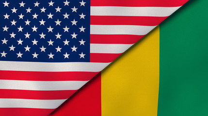 Fototapeta premium The flags of United States and Guinea. News, reportage, business background. 3d illustration