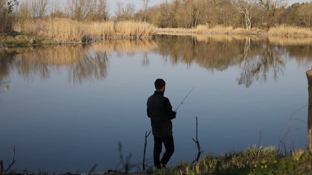 Man catches spinner on river.