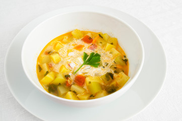a bowl of vegetarian soup with sour cream decorated with parsley