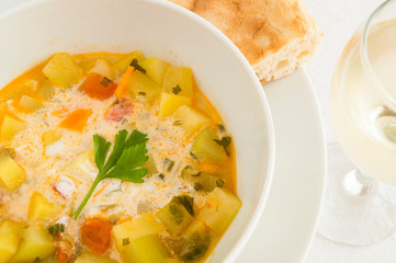 vegetable soup with sour cream served with pita and white wine