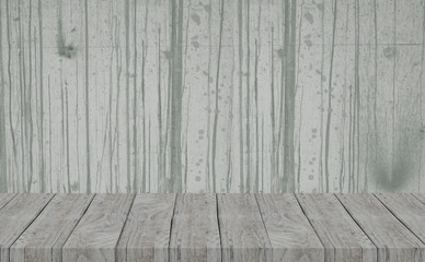 The grey color rough concrete wall and line of cement drops on background surface with gray wooden table