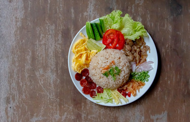 Rice Seasoned with Shrimp Paste or Khaao Khlook Gabpi in Transparent plastic lunch box. A simple and basic Thai food. Each of the dish’s components is separately prepared, set aside and mixed when eat