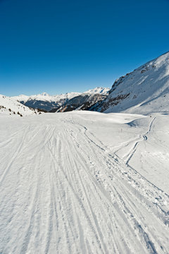 View down a piste in alpine ski resort