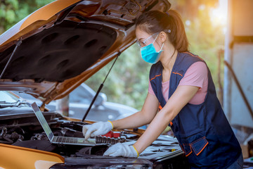 Portrait woman car mechanic with smile face repairs and check car problem system for maintenance...