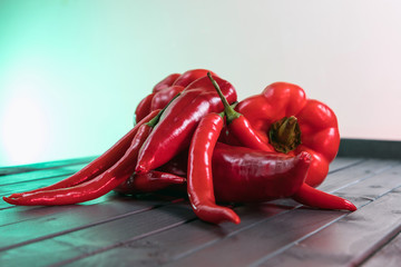 Juicy ripe peppers. Assortment of different peppers. Vegetables on a dark wooden table. Bright...