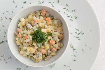 russian salad dressed with mayonnaise and decorated with  dill