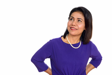 Fototapeta premium Studio shot of happy mature Asian woman thinking isolated against white background