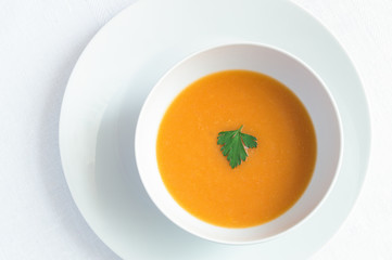 pumpkin soup puree decorated with parsley leaf