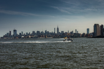 New York City with buildings, streets, during clear day