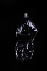 empty plastic bottle for recycling over dark background