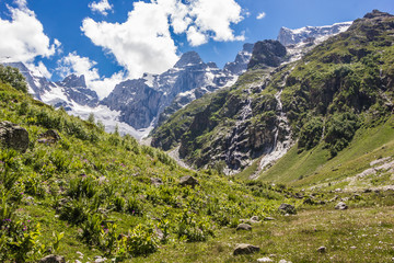 Fototapeta na wymiar Alpine meadows and rocks in the Caucasus mountains in Russia. Peak Dalar.