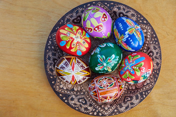  Beautiful easter eggs on a wooden plate