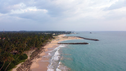 Beautiful beach with blue water and palm on Sri Lanka