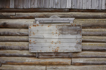 A boarded-up window in an old abandoned village house.