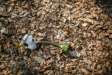 A Soviet gas mask lies on last year's leaves