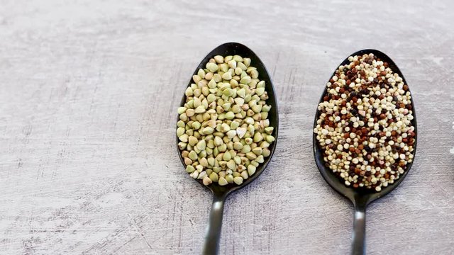 healthy plant-based diet, spoons lined up on kitchen counter with mixed grains and carbs including buckwheat quinoa rice and breadcrumbs and camera panning horizontally