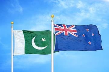 Pakistan and New Zealand two flags on flagpoles and blue cloudy sky