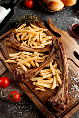 fresh kebab with french fries on wooden board