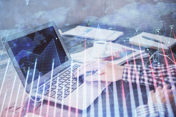 Double exposure of forex chart with man working on computer on background. Concept of market analysis.