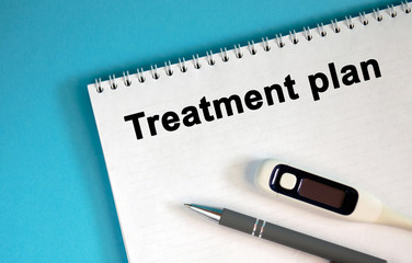 HEALTH PLAN - text on a notepad. Lie a pen and a medical thermometer