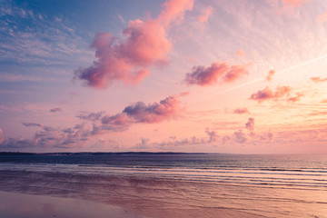 Naklejka na ściany i meble Colorful sunset and fluffy clouds on the sea.