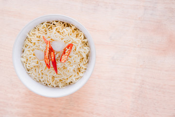 Top view instant noodle topping with red chili and onion