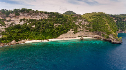 Fototapeta premium Aerial view on Pura Temple on hardly accessible deserted Suwehan beach. Nusa Penida paradise Island, Indonesia.