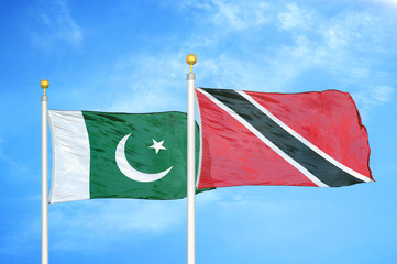Pakistan and Trinidad and Tobago two flags on flagpoles and blue cloudy sky