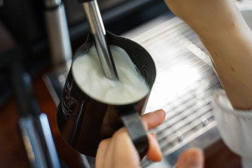 Barista making coffee ,steaming milk , Pouring latte art