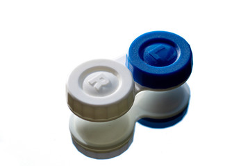Blue and white contact lens case on white background isolated mirrored