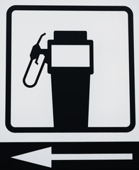 
A black and white sign indicating that the service station is on the left. Square format.