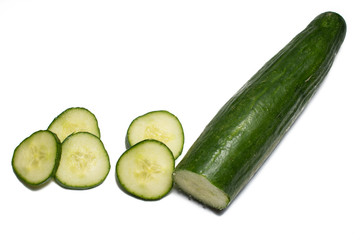 Slice of cucumber on white background. Cucumber whole and cut, being prepared for food.