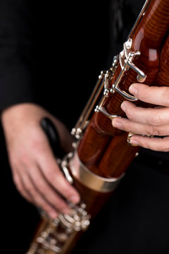 Wooden bassoon isolated on a black background. Musical instruments. Musician playing the instrument.