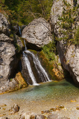 Enipeas waterfall with small lake surrounded by trees