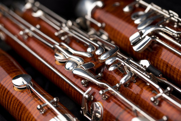 Wooden bassoon isolated on a black background. Music instruments.