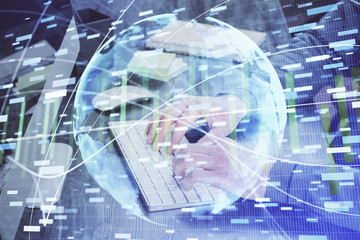 Double exposure of businessman working on laptop on background. International business hologram in front. Concept of success.