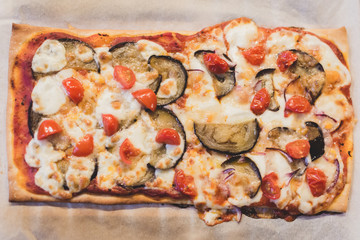 Homemade pizza with aubergine, tomatoes and mozzarella.