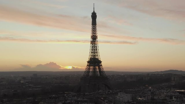 AERIAL: Over Paris, France wet, reflections from Rain with view on Eiffel Tower, Tour Eiffel in Beautiful Sunset Light 