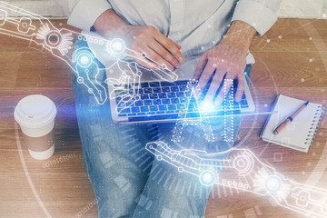 Multi exposure of data internet theme hologram with man working on computer on background. Concept of innovation.