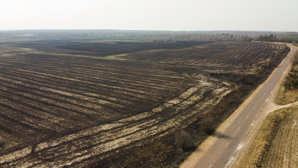 Forest and field fire. Dry grass burns, natural disaster. Aerial view. After the fire