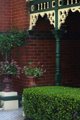 Entrance of an Federation house. Showing the front garden with Two glazed terracotta urns with...