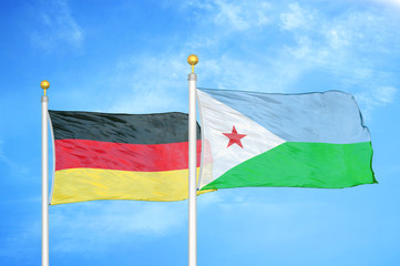 Germany and Djibouti two flags on flagpoles and blue cloudy sky