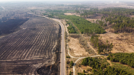 Forest and field fire. Dry grass burns, natural disaster. Aerial view. After the fire