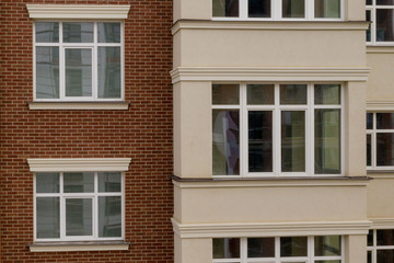 The property. New modern building with balconies, close-up, fragment. Close-up of glass balconies of modern hotel building