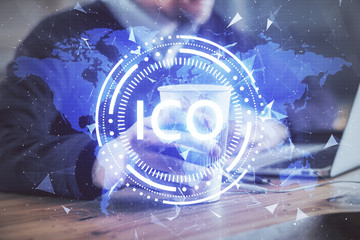 Crypto currency theme hologram with businessman working on computer on background. Concept of...