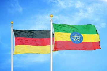 Germany and Ethiopia two flags on flagpoles and blue cloudy sky