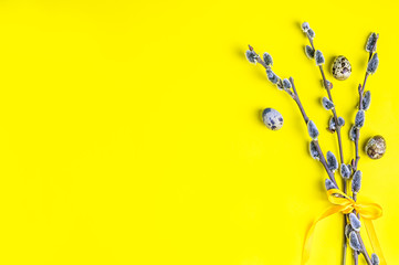 willow on a yellow background. quail eggs. Spring, Easter.