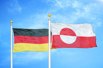 Germany and Greenland two flags on flagpoles and blue cloudy sky