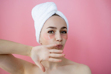 Portrait of Beauty Woman with Eye Patches on pink background. Woman Beauty Face with Mask under Eyes. Skin care, cosmetic product concept